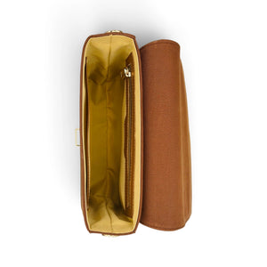 A brown denim shoulder bag by needlesay shown open from a top-down view, revealing a mustard yellow interior lining and a zippered pocket, next to its matching brown closed exterior.