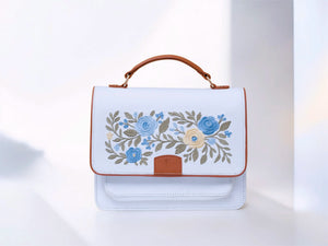 needlesay ivory White handbag with floral embroidery on a white background