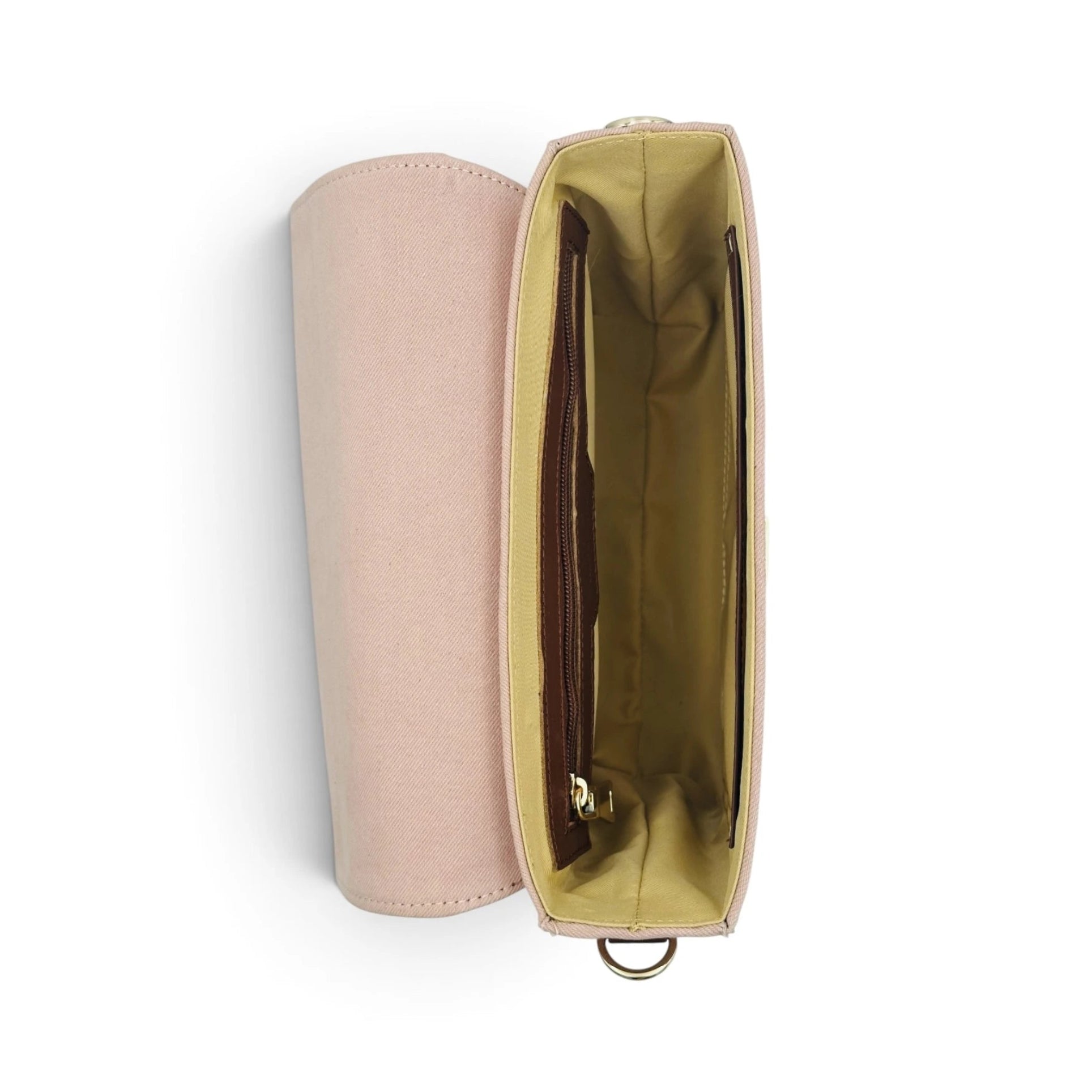 A light pink denim and leather shoulder bag of needlesay called botanica blush shown open from a top-down view, revealing a mustard yellow interior lining and a brown cardholder pocket.