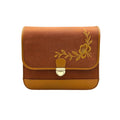 A rectangular brown envelope-style needlsay denim bag with a gold floral embroidery on the front flap and a gold metal clasp, shown against a plain white background.