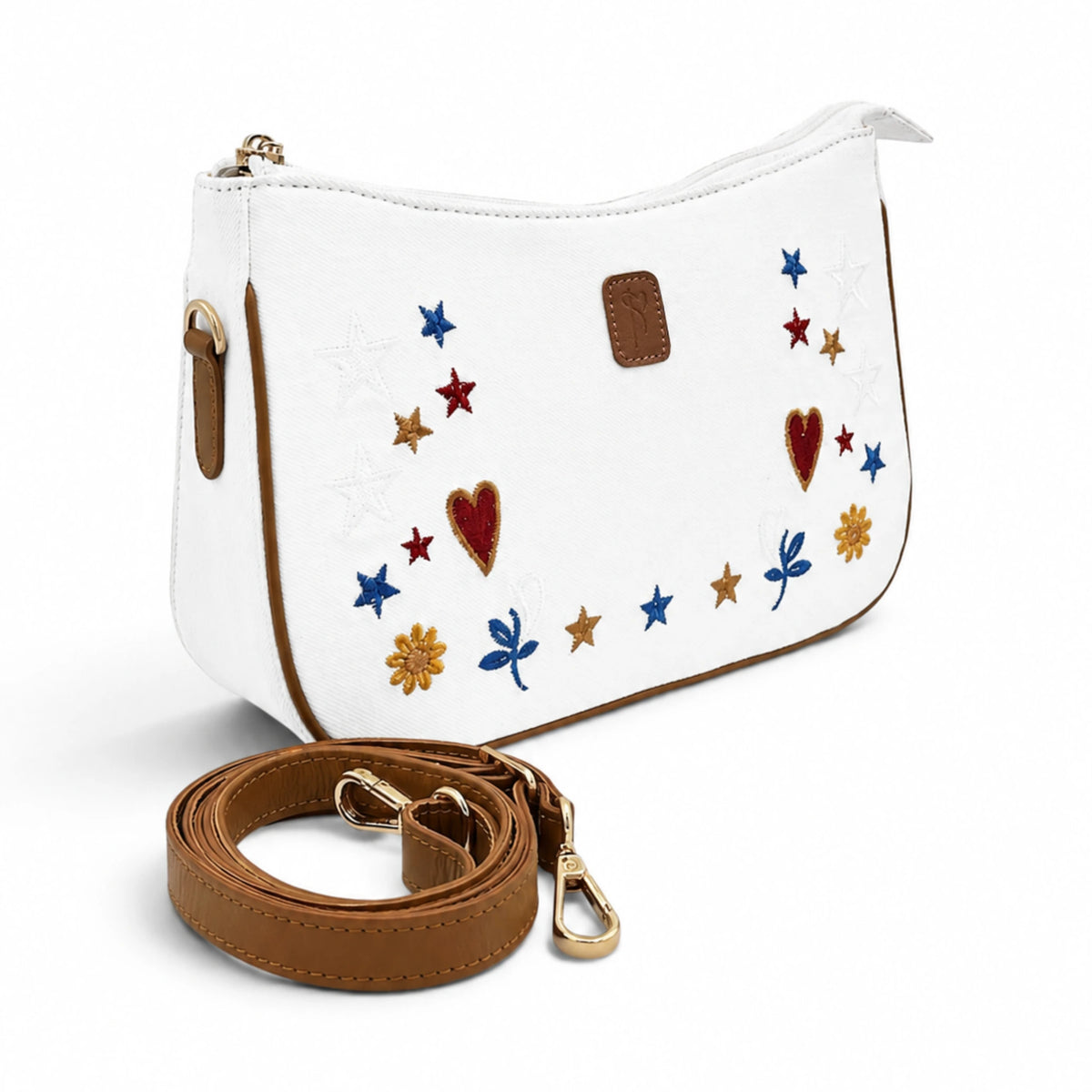 Needlesay White cross body / shoulder bag with brown trim and strap, decorated with embroidered stars, hearts, flowers, and dragonflies in blue, red, and gold, shown on a white background with the strap in front.