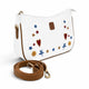 Needlesay White cross body / shoulder bag with brown trim and strap, decorated with embroidered stars, hearts, flowers, and dragonflies in blue, red, and gold, shown on a white background with the strap in front.